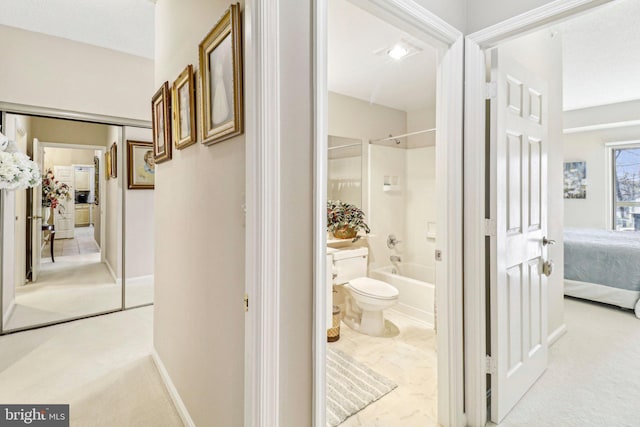 bathroom featuring washtub / shower combination and toilet