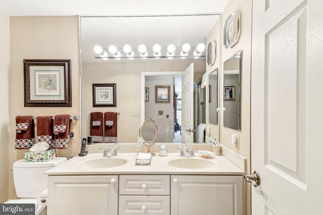 bathroom featuring vanity and toilet