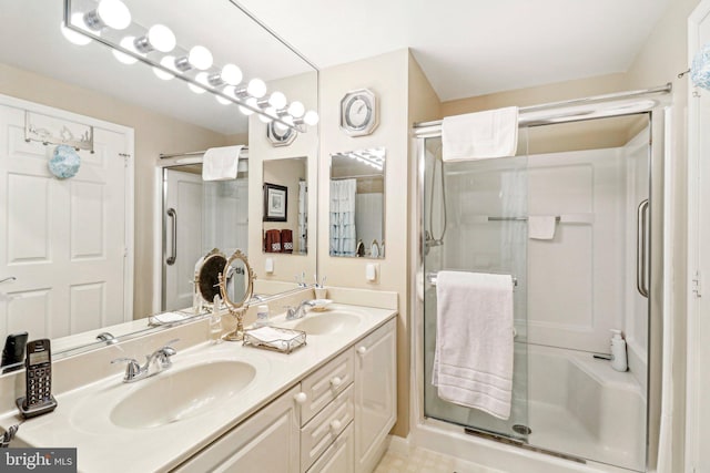 bathroom with vanity and a shower with shower door