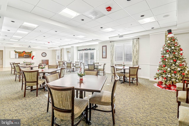 dining area featuring a paneled ceiling and carpet