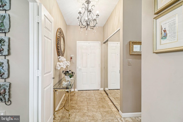 interior space with a textured ceiling and an inviting chandelier