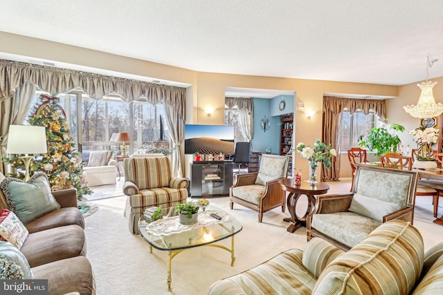 living room with carpet floors, a textured ceiling, and a notable chandelier