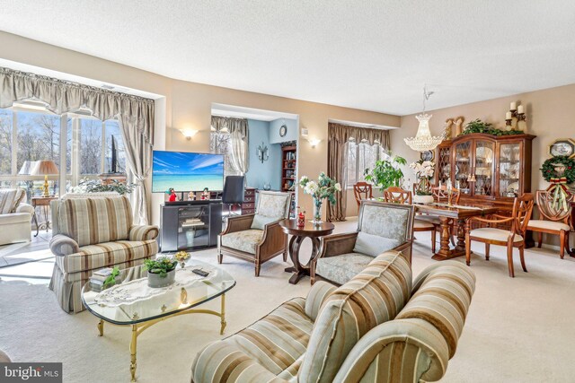 carpeted living room with a textured ceiling and an inviting chandelier