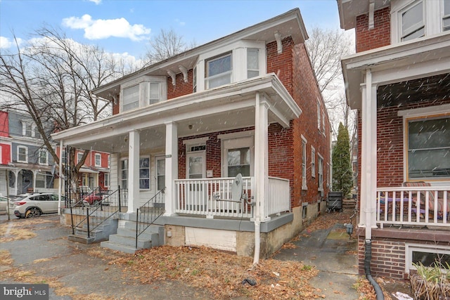 view of property featuring covered porch