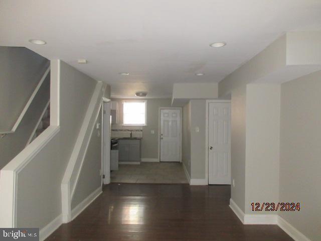 corridor featuring dark wood-type flooring