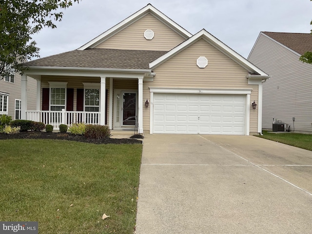 view of front of property with central air condition unit, a porch, a front yard, and a garage