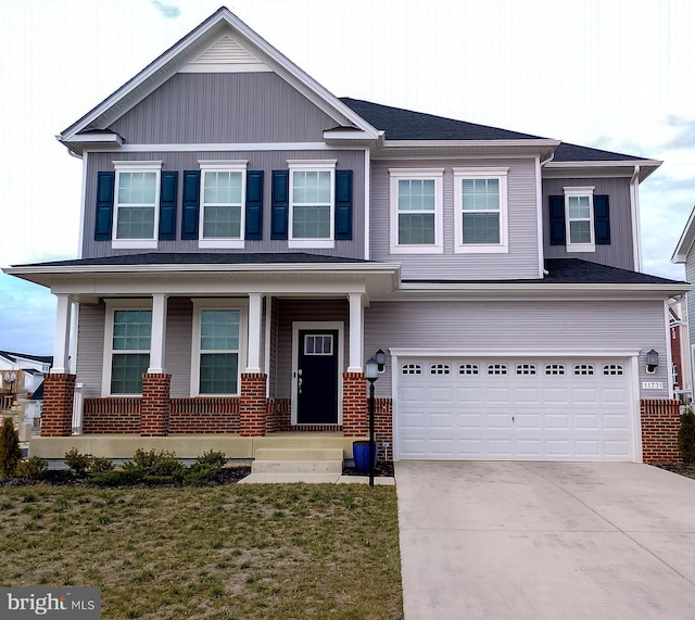 view of front of property featuring a front yard and a garage