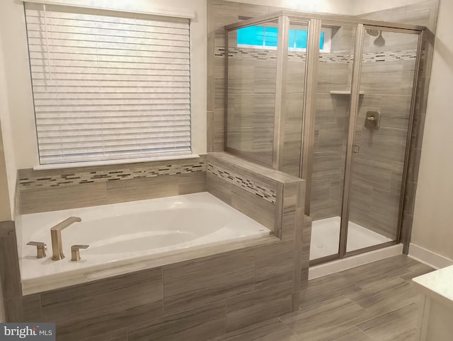 bathroom with shower with separate bathtub