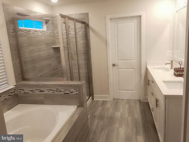 bathroom with vanity and separate shower and tub