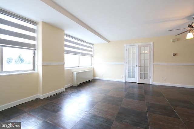 unfurnished room featuring ceiling fan, a wealth of natural light, and french doors