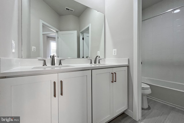 full bathroom with bathtub / shower combination, vanity, and toilet