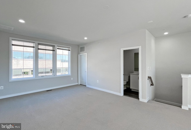 unfurnished room with light colored carpet