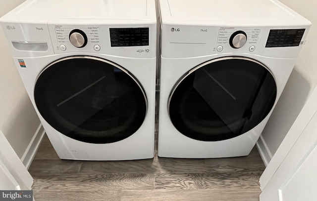 washroom featuring washer and dryer and wood-type flooring