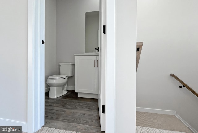 bathroom with wood-type flooring and toilet