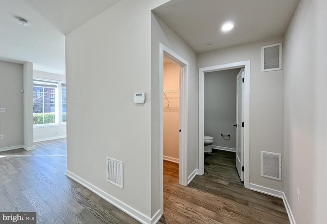 corridor featuring dark hardwood / wood-style flooring