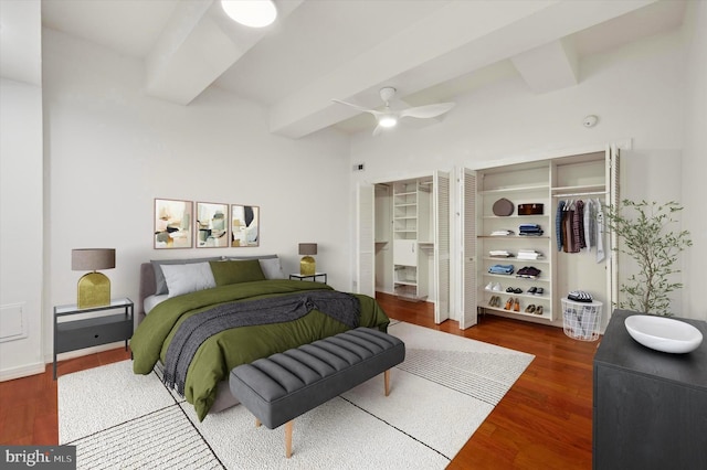 bedroom featuring beam ceiling, ceiling fan, and dark hardwood / wood-style floors