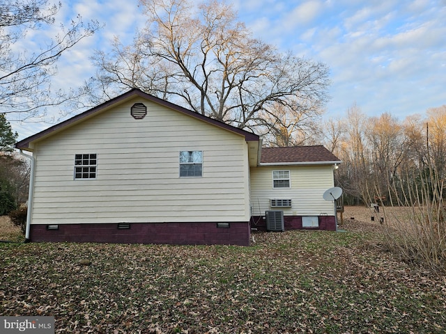 view of side of property with central air condition unit