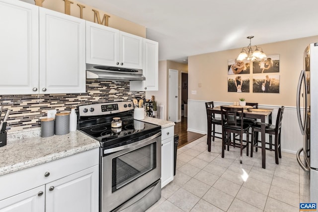 kitchen featuring a chandelier, decorative light fixtures, stainless steel appliances, and white cabinetry