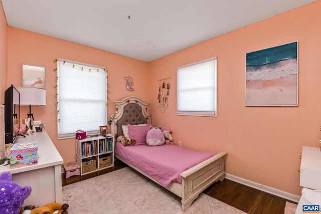 bedroom featuring light wood-type flooring and multiple windows