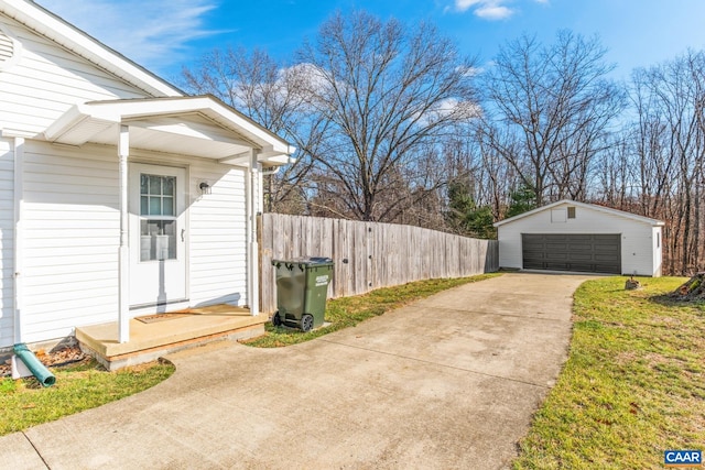 view of side of home featuring a garage and an outbuilding