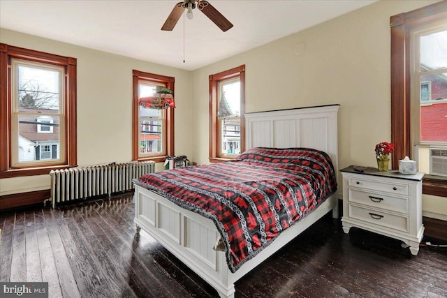 bedroom featuring radiator, dark wood-type flooring, and ceiling fan