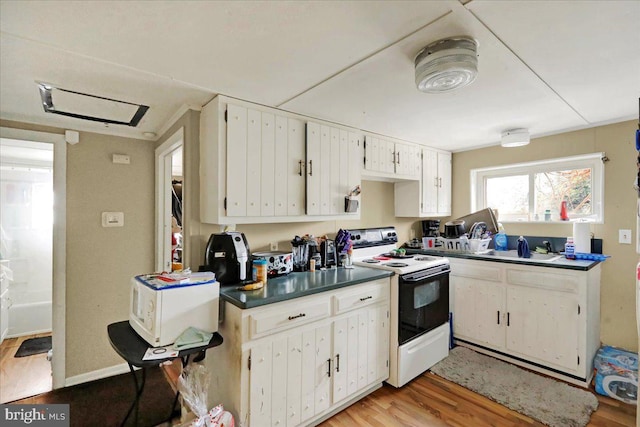 kitchen with light hardwood / wood-style floors, white cabinetry, white appliances, and sink