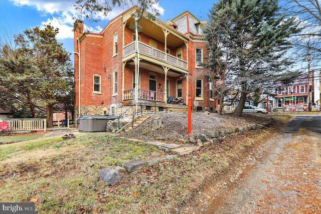 back of property featuring a balcony