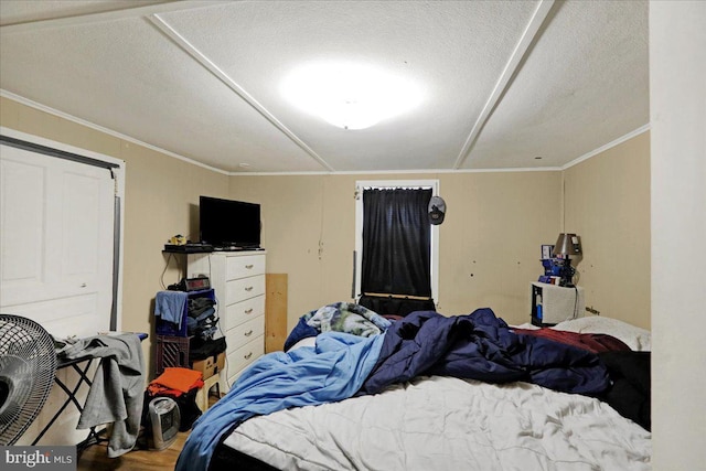 bedroom featuring a textured ceiling and ornamental molding