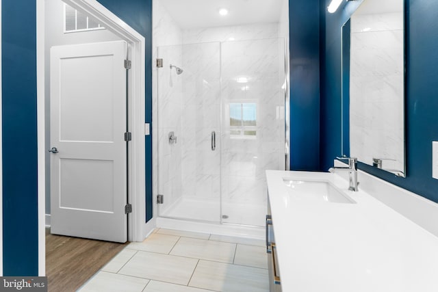 bathroom with visible vents, vanity, and a marble finish shower