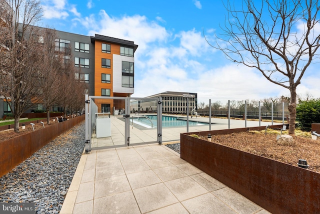 pool featuring a patio area and fence