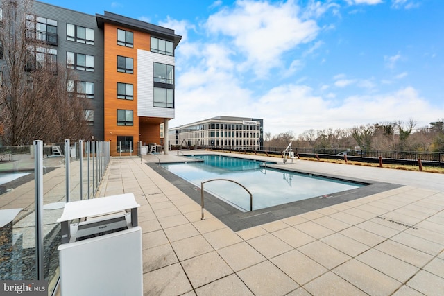 community pool featuring a patio area and fence