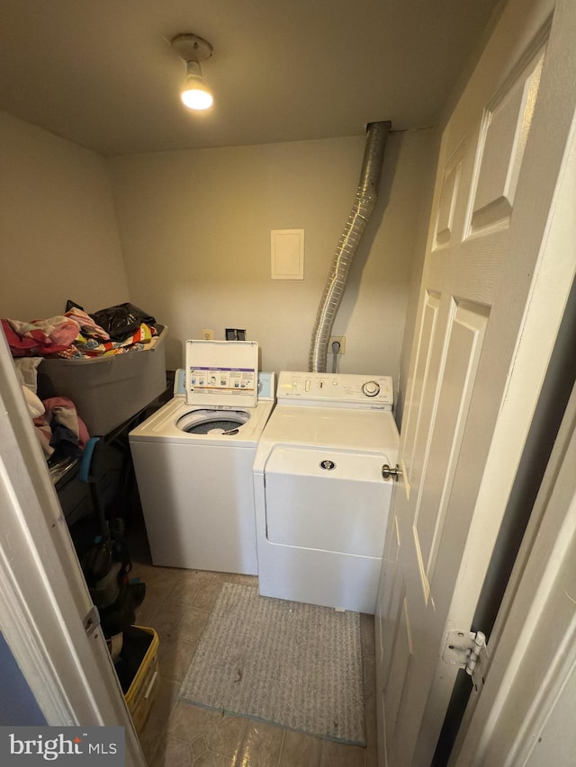 clothes washing area with tile patterned flooring and separate washer and dryer