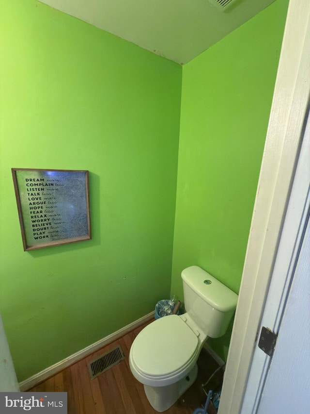 bathroom featuring hardwood / wood-style floors and toilet