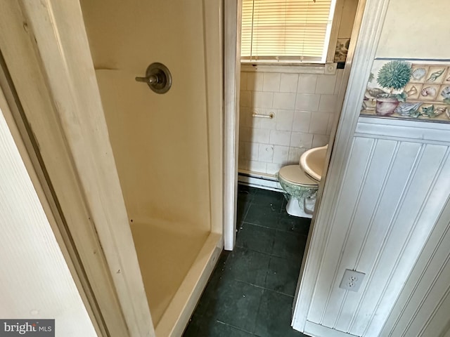 bathroom with tile patterned floors, toilet, and a baseboard radiator