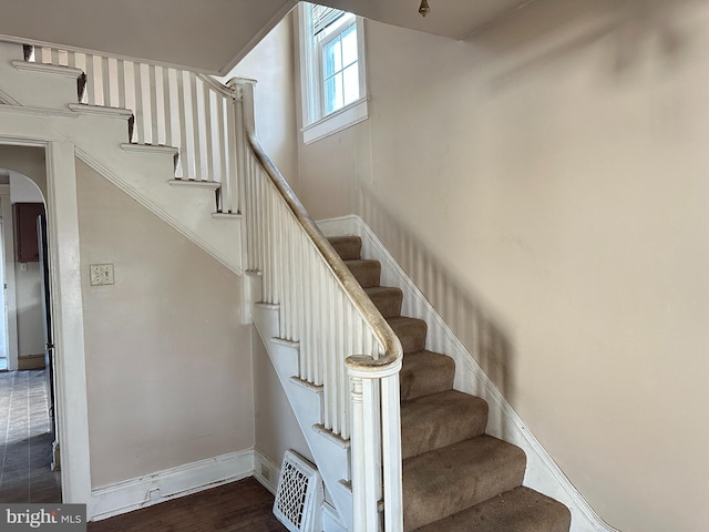 staircase with hardwood / wood-style flooring