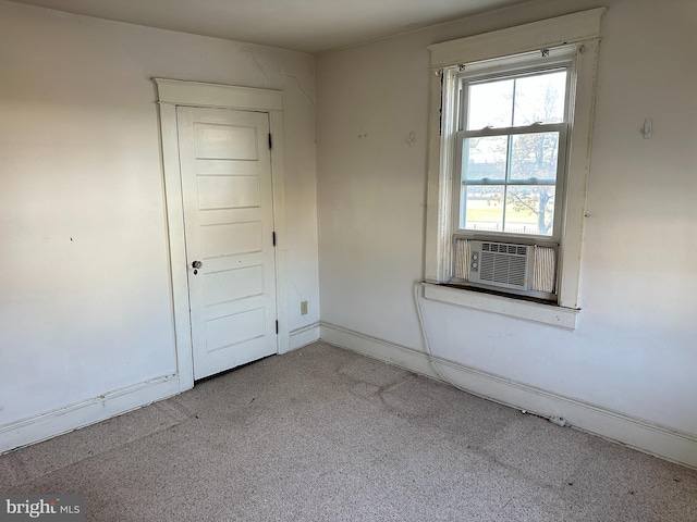 carpeted spare room featuring cooling unit