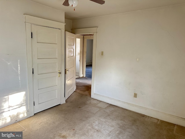 unfurnished bedroom featuring light carpet and ceiling fan