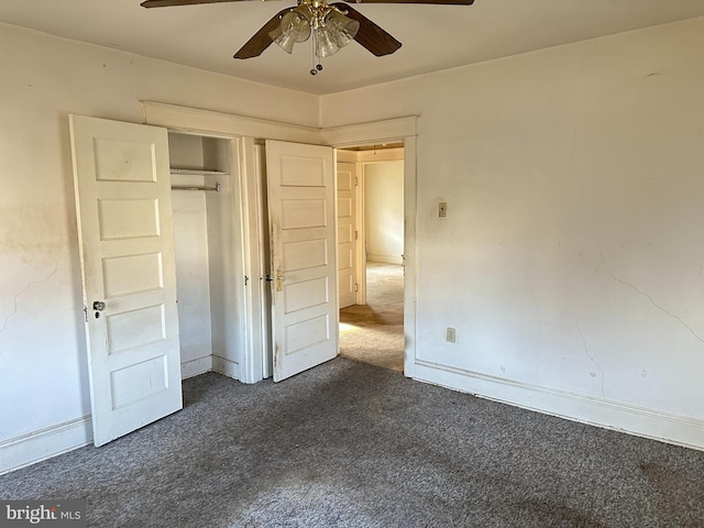 unfurnished bedroom with ceiling fan, a closet, and dark colored carpet