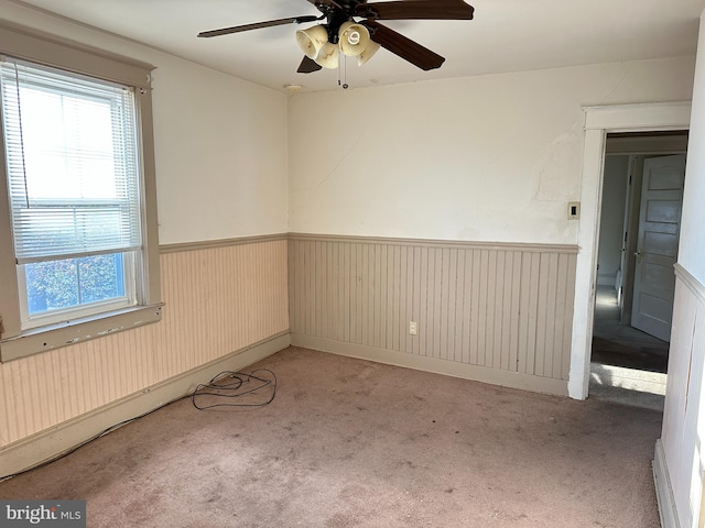 spare room with light carpet and ceiling fan