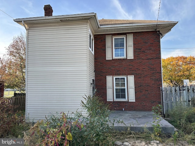 view of side of property with a patio area