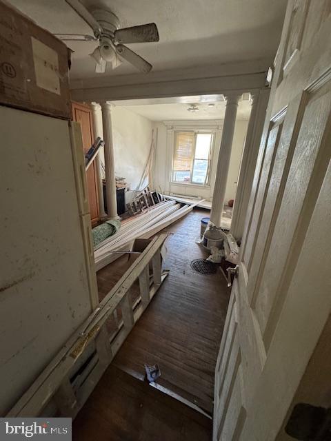 miscellaneous room featuring dark hardwood / wood-style flooring, decorative columns, and ceiling fan