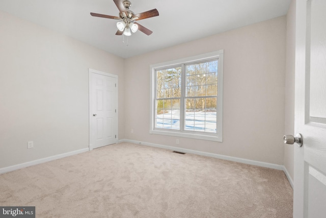 empty room with light carpet and ceiling fan