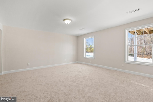 carpeted empty room with a wealth of natural light