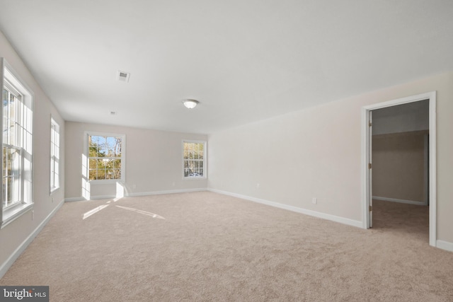 carpeted empty room featuring a healthy amount of sunlight