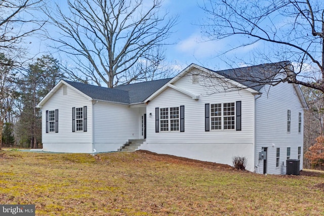 view of front of house featuring central AC unit and a front lawn