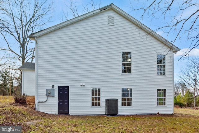 back of property with central AC