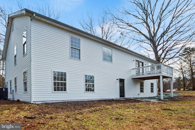 rear view of house with central air condition unit, a patio, and a deck