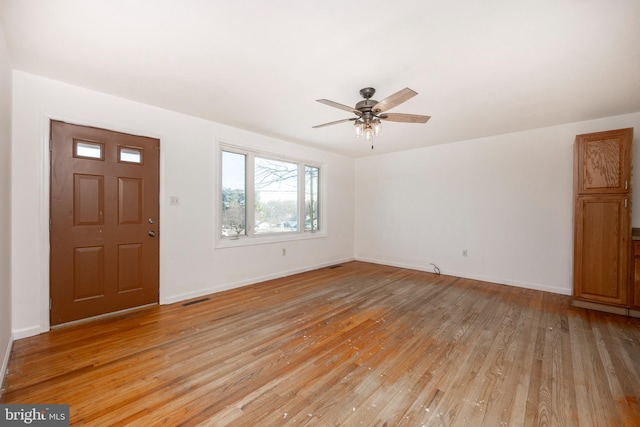 foyer entrance with light hardwood / wood-style floors and ceiling fan