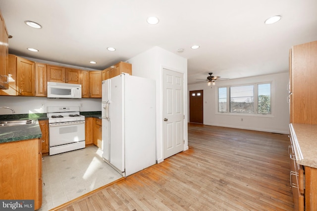 kitchen with white appliances, light hardwood / wood-style flooring, ceiling fan, and sink