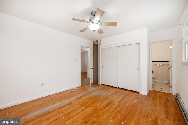 unfurnished bedroom featuring ceiling fan, light wood-type flooring, a baseboard radiator, and a closet